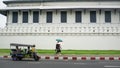 A couple and tuk tuk was passing a Grand Royal Palace area, Bangkok Thailand Royalty Free Stock Photo