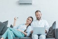 couple turning on air conditioner during the summer heat while Royalty Free Stock Photo