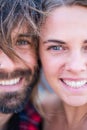Couple of two adults and beautiful and attractive people looking at the camera - portrait and close up of woman and man smiling Royalty Free Stock Photo