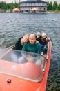 A couple with two children enjoying a romantic vacation on a traditional motor boat on river Royalty Free Stock Photo