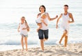 Couple with two children running Royalty Free Stock Photo