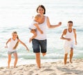 Couple with two children running Royalty Free Stock Photo
