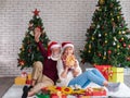 Couple of two happy and cheerful senior adults with Santa hat celebrating new year, new life and Christmas at home with decorated Royalty Free Stock Photo