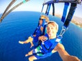 Couple of two happy people enjoying summer and vacations doing extreme activity on the sea with a boat - beautiful people taking a Royalty Free Stock Photo