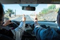 Couple of two seniors together in a car doing the yes sign with their hands - active mature woman drivinng a car with her husband Royalty Free Stock Photo