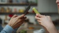 Couple typing smartphones ignoring each other at home close up. Unhappy family.