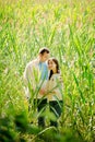 Couple in Ukrainian shirts in a field with corn