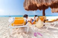 Couple under parasol at Caribbean Sea