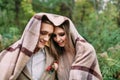 Couple under the plaid in an autumn romantic forest. Autumn wedding outdoors.