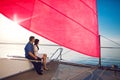 Couple under the red sail Royalty Free Stock Photo