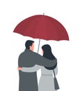 Couple under a red umbrella. A young man hugs a woman. Back view Royalty Free Stock Photo