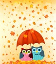 Couple under umbrella at autumn