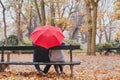 Couple under umbrella in autumn park, love concept