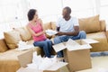 Couple unpacking boxes in new home