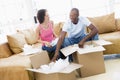 Couple unpacking boxes in new home