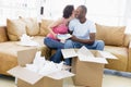 Couple unpacking boxes in new home kissing
