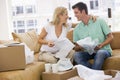 Couple unpacking boxes in new home smiling Royalty Free Stock Photo
