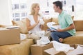 Couple unpacking boxes in new home smiling Royalty Free Stock Photo