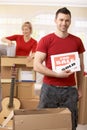 Couple unpacking boxes in new house