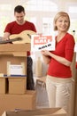 Couple unpacking boxes in new house