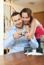 Couple unpacking new compact digital camera Royalty Free Stock Photo