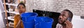 Couple Using Bucket For Collecting Water Leakage From Ceiling Royalty Free Stock Photo