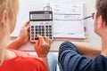 Couple Using Calculator For Calculating Invoice Royalty Free Stock Photo