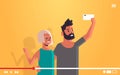 Couple using cellphone man woman taking selfie photo on smartphone camera live video streaming broadcast social media Royalty Free Stock Photo