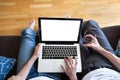 Couple using computer with empty screen Royalty Free Stock Photo