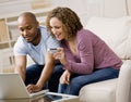 Couple using credit card to shop online