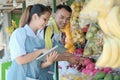 Couple using digital tablet while choosing good stuff when prepare