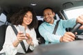 Couple using GPS app on phone planning route driving car Royalty Free Stock Photo