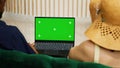 Couple using greenscreen on laptop