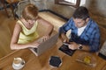 Couple using laptop computer and mobile phone networking ignoring each other Royalty Free Stock Photo