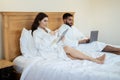 Couple Using Laptop And Digital Tablet In Bed At Hotel Royalty Free Stock Photo