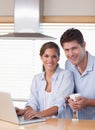 Couple using a laptop while having coffee Royalty Free Stock Photo