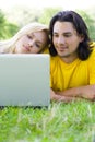 Couple using laptop outdoors Royalty Free Stock Photo