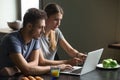 Couple using laptop for reading news or work having breakfast Royalty Free Stock Photo