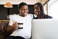 Couple using laptop while sitting on couch at home. Royalty Free Stock Photo