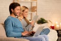 Couple Using Laptop And Tablet Computers Sitting On Couch Indoor Royalty Free Stock Photo