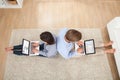 Couple using laptops in living room Royalty Free Stock Photo