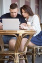 Couple using notebook at a cafe Royalty Free Stock Photo