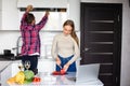 Young couple using a notebook to cook in their kitchen Royalty Free Stock Photo