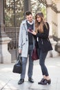 Couple using phone in street