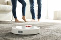 Couple using robotic vacuum cleaner