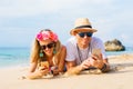 Couple using their phones on the beach Royalty Free Stock Photo