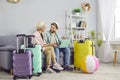 Couple vacation happy online tour choosing and registration, packing suitcase together, planning Royalty Free Stock Photo