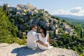 Couple on vacation in Southern france looking out over the old historical village of Gordes Luberon