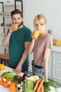 couple of vegans drinking fresh juice at kitchen