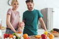 couple of vegans preparing juice with squeezer